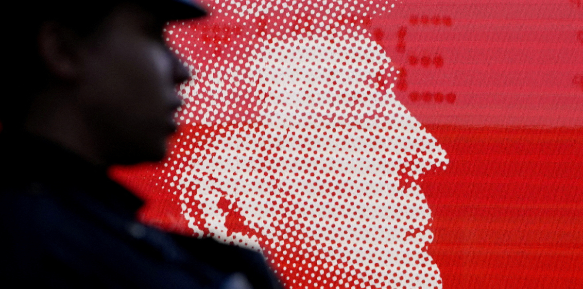 A New York Police Department officer stands in front of an image of Republican presidential nominee Donald Trump outside Madison Square Garden in New York City, October 27, 2024. (David Dee Delgado/REUTERS)